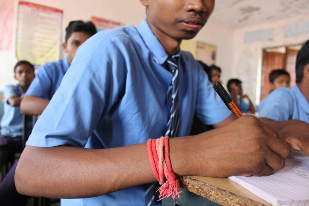 SCHOOL KID WRITING IN UNIFORM