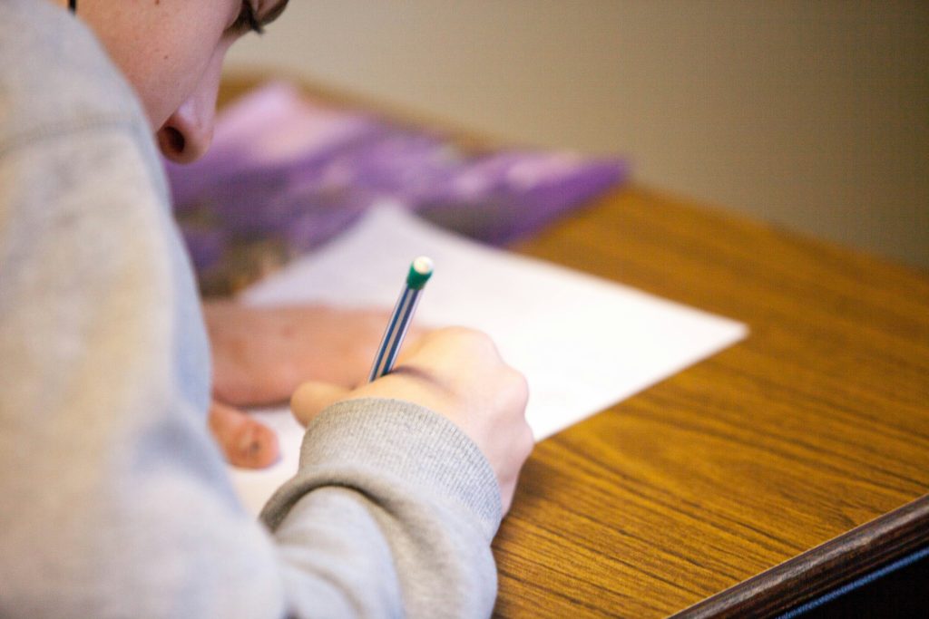 A KID WRITING IN CLASS